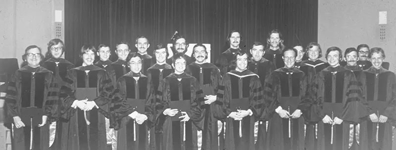 Black and white photo of people at graduation