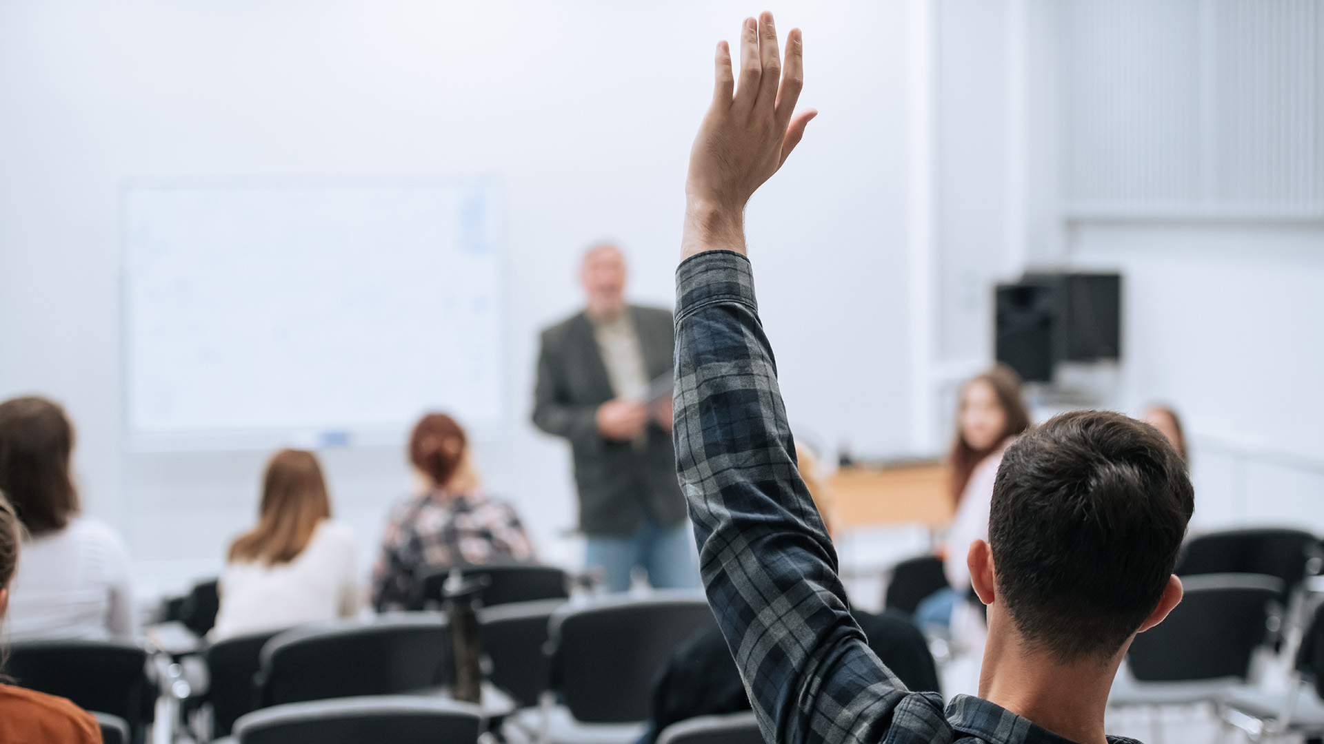 A famous professor has arrived at the university to conduct a special lesson, the student pulls his hand up to ask him a question.