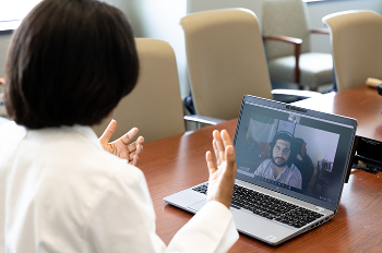 Photo of a doctor and patient in a telemedicine session. Even with access to telemedicine, many PTSD patients do not finish their treatment. A new study from UTHealth is looking at innovative ways to change that. (Photo by Rogelio Castro/UTHealth)