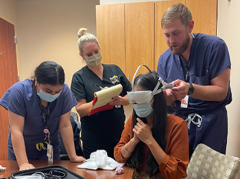 A research team led by Summer Ott, PsyD, practices the placement of the Nurocheck device for future patients with concussions. From left to right: Keyla D. Guevara, Ott, Tanya Cheema, Jordan J. Harmon. (Photo courtesy of Dr. Summer Ott)