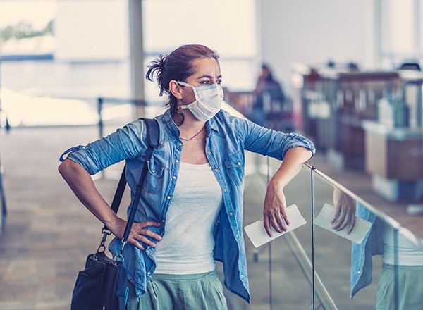 Photo of women at the airport, showing many are facing tough decisions to make about holiday travel as the U.S. Centers for Disease Control and Prevention strongly advises against holiday travel. (Photo credit: Getty Images)