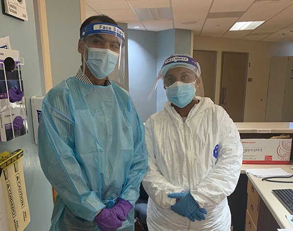Photo of Doctor Lokesh Shahani and nurse Roshan Cherian wearing PPE to work in a special COVID-19 unit  at UTHealth Harris County Psychiatric Center. Photo by UTHealth.