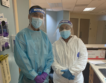 Photo of Doctor Lokesh Shahani and nurse Roshan Cherian wearing PPE to work in a special COVID-19 unit  at UTHealth Harris County Psychiatric Center. Photo by UTHealth.