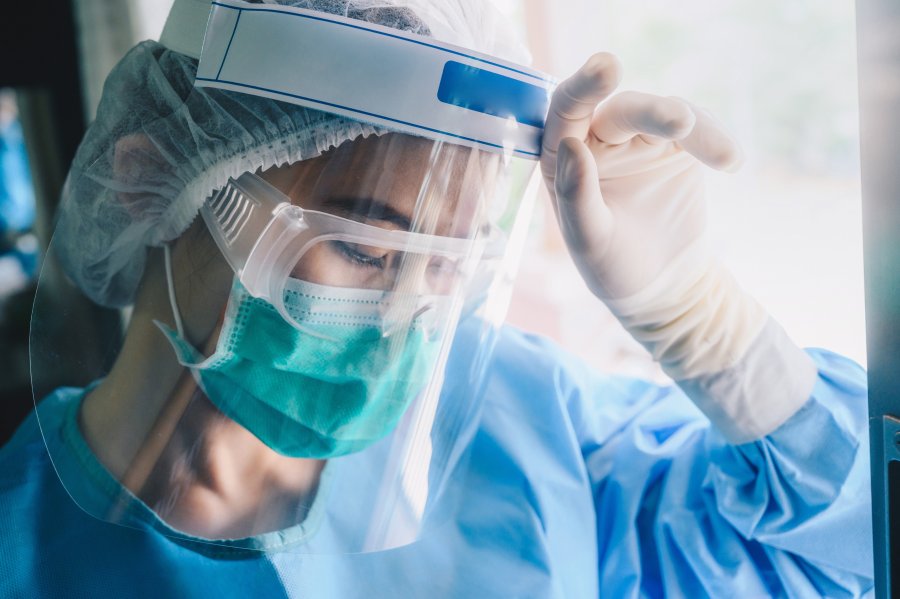 Picture of a nurse with mask and face shield