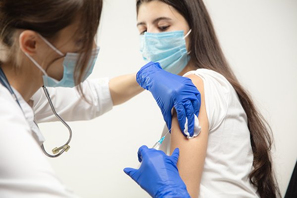An image of a young girl receiving a vaccination. (Photo by Getty Images).