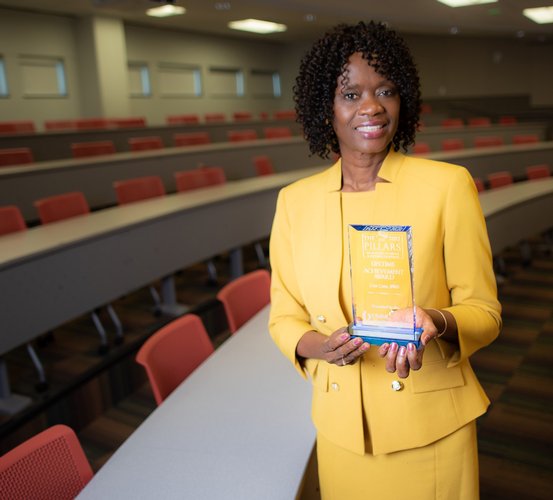 Dr. Lisa Cain holds her 2022 University of Mississippi Medical Center’s Lifetime Achievement Award.