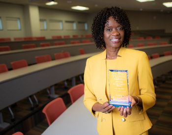 Dr. Lisa Cain holds her 2022 University of Mississippi Medical Center’s Lifetime Achievement Award.