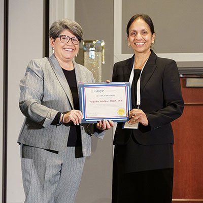 Sujatha Sridhar (right), MBBS, MCE, receives the AAHRPP 2023 Lifetime Achievement Award. (Courtesy photo)