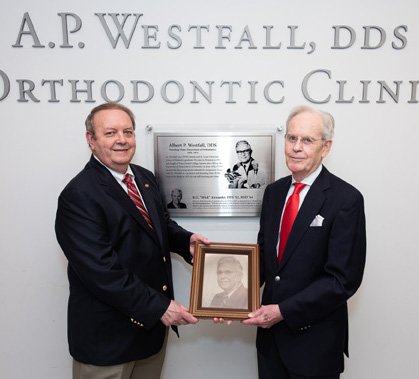 Dr. Jeryl English (left) and Dr. R.G. “Wick” Alexander hold a photograph of Dr. A.P. Westfall, who founded UTHealth School of Dentistry’s Department of Orthodontics in 1956.