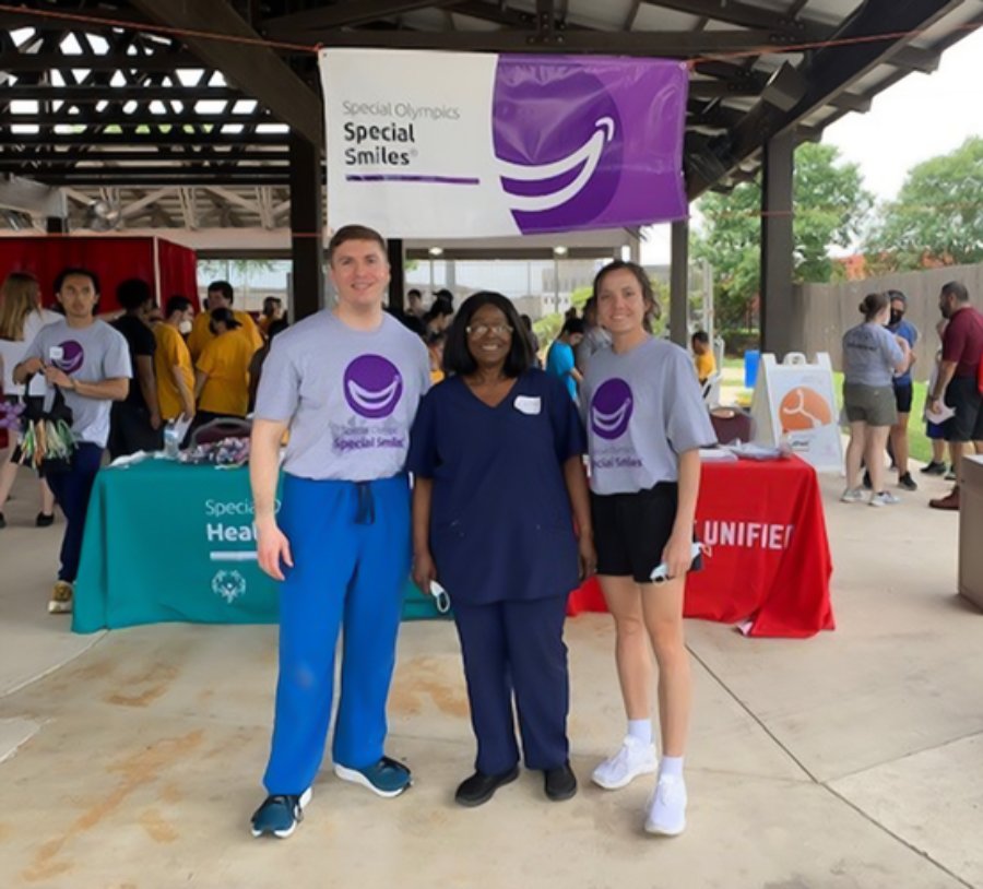 Dental students Andre Larue (left) and Camille Hoover (right) with Dr. Esther Kuyinu at the 2022 Special Olympics Texas Summer Games in San Antonio.