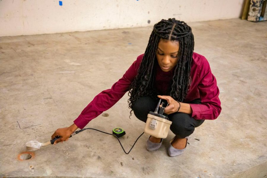 A Texas Southern University student uses a Geiger counter to detect and measure residual radiation in the medical school’s former cyclotron facility. (Photo by McGovern Medical School)