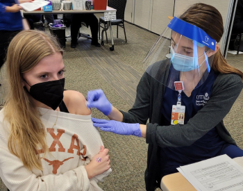 Photo of Courtney Lake receiving her COVID-19 vaccination through UTHealth and UT Physicians. (Photo by Deb Lake)