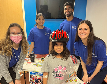 Local children received 130 bicycle helmets during a giveaway last month at a UT Physicians pediatric clinic. (Photo by Simone Sonnier/UT Physicians)