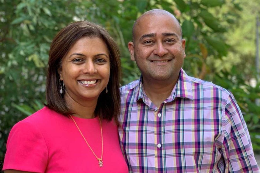 Photo of Shreela Sharma and husband Vibhu Sharma. Both are smiling, pictured with greenery behind them. (Photo credit: Rachael Atterstrom/UTHealth)