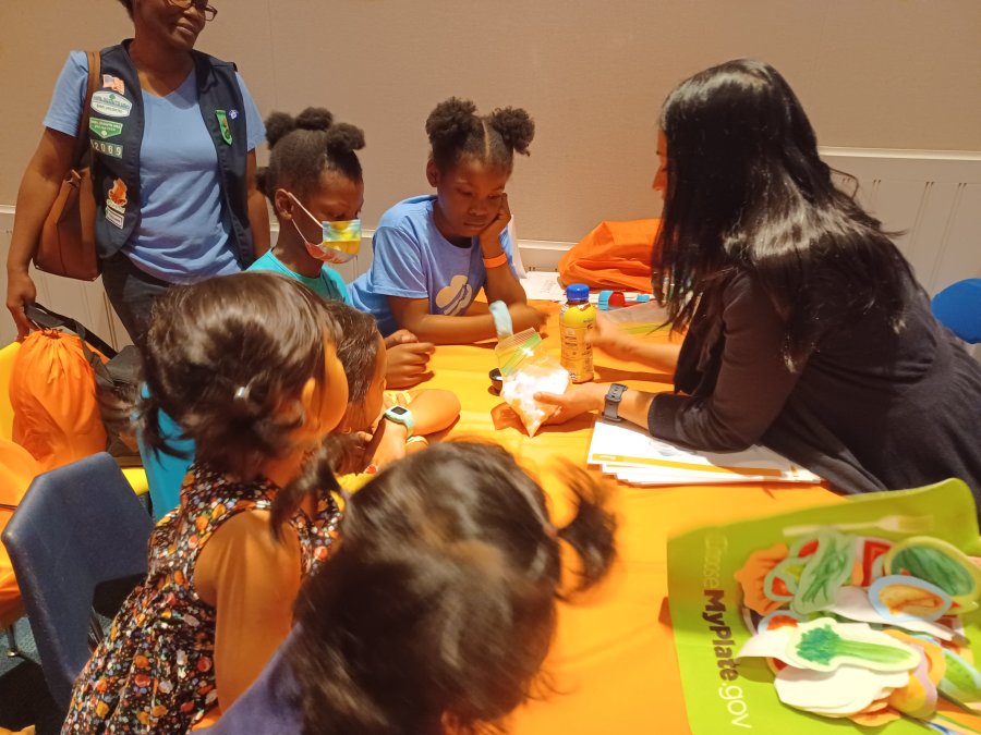 Volunteers teach girl scouts the importance of brain health and nutrition