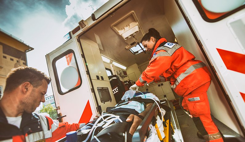 Photo of paramedics loading a patient in an ambulance for a story about new research on whether cold stored platelets administered in the ambulance can help save patients. Photo by Getty Images