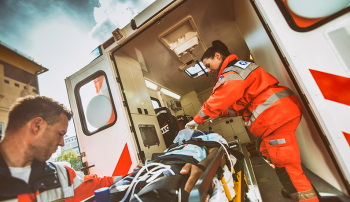 Photo of paramedics loading a patient in an ambulance for a story about new research on whether cold stored platelets administered in the ambulance can help save patients. Photo by Getty Images