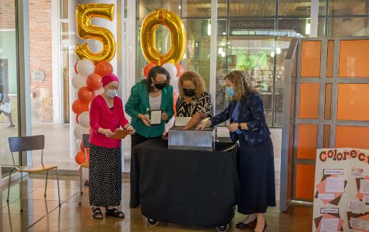 Image of a group of people opening the time capsule. (Photo by Nathan Jeter/UTHealth Houston)