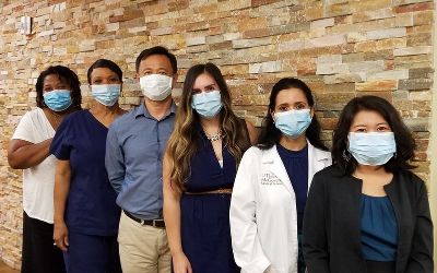 Photo of the UTHealth Student Counseling Services team masked and taking COVID-19 precautions.