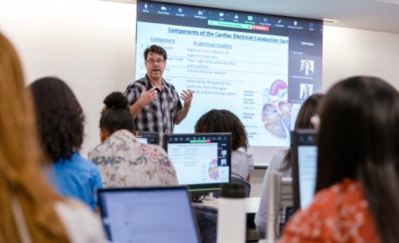 Shane Cunha, PhD, teaches in a hybrid classroom that consists of both in-person and remote students at McGovern Medical School.