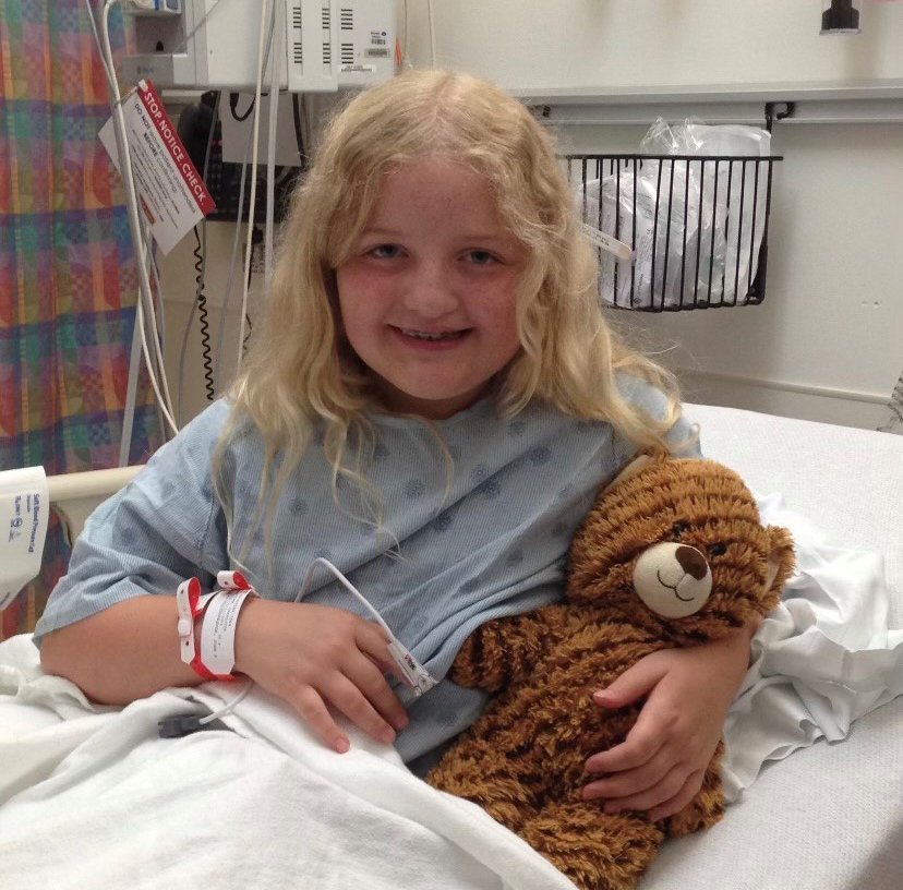 Charlie posing with her favorite teddy bear before her surgery in 2014. (Photo courtesy of Charlie Brown)