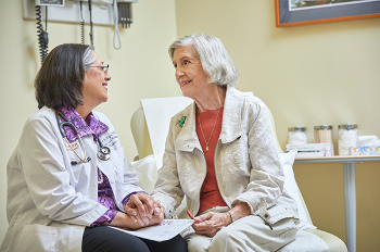 Photo of Dr. Carmel Dyer with a patient.
