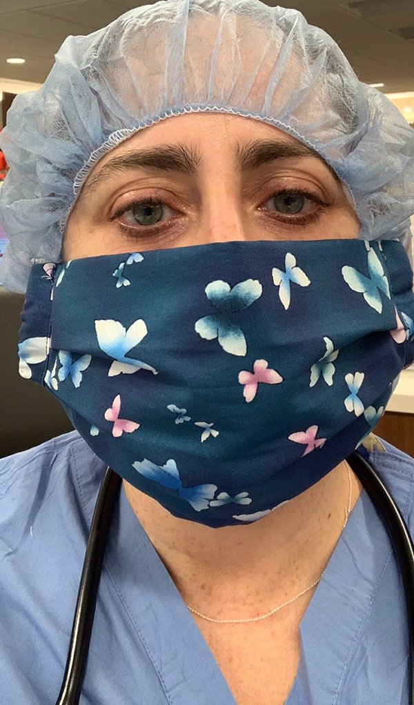 Photo of Hilary Fairbrother, MD, MPH, wearing a face mask over her personal protective equipment (PPE) to make her PPE last longer. (Photo credit: Hilary Fairbrother, MD, MPH)