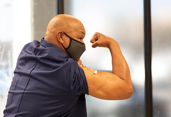 Community advocate and boxing legend George Foreman encourages others to take the COVID-19 vaccine. (Photo by Cody Duty, UTHealth)