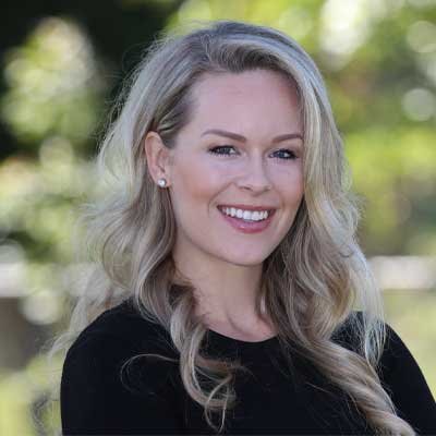Headshot of Taylor Harrell, PhD. She's wearing a black shirt, and is pictured outside. (Courtesy photo)