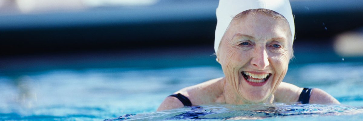 Aging Woman Wearing a Swimming Cap in a Pool