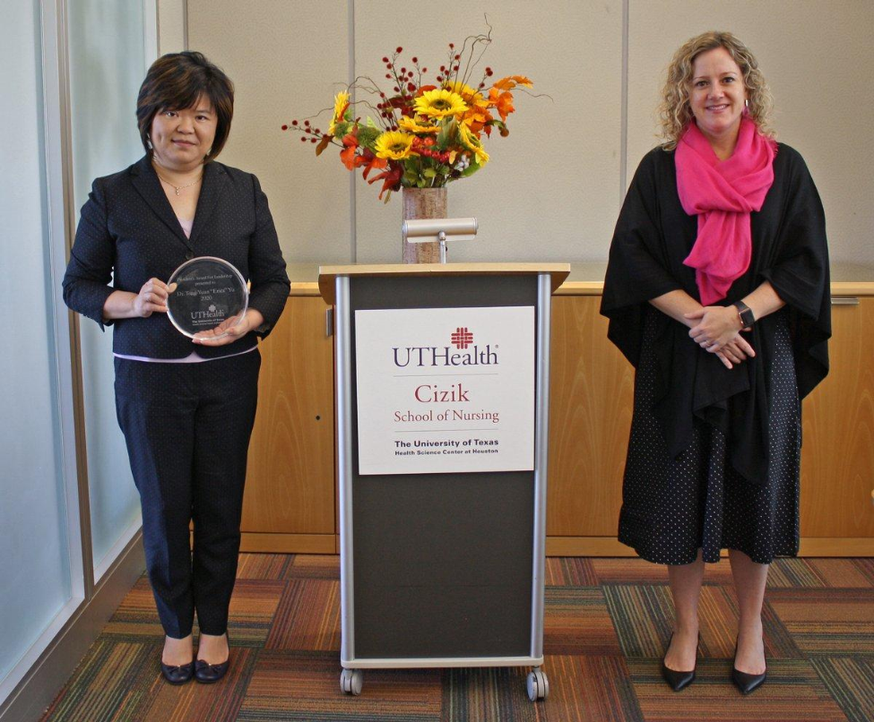 (L-R) Dr. Erica Yu receives her President's Award for Leadership from Dean Diane Santa Maria