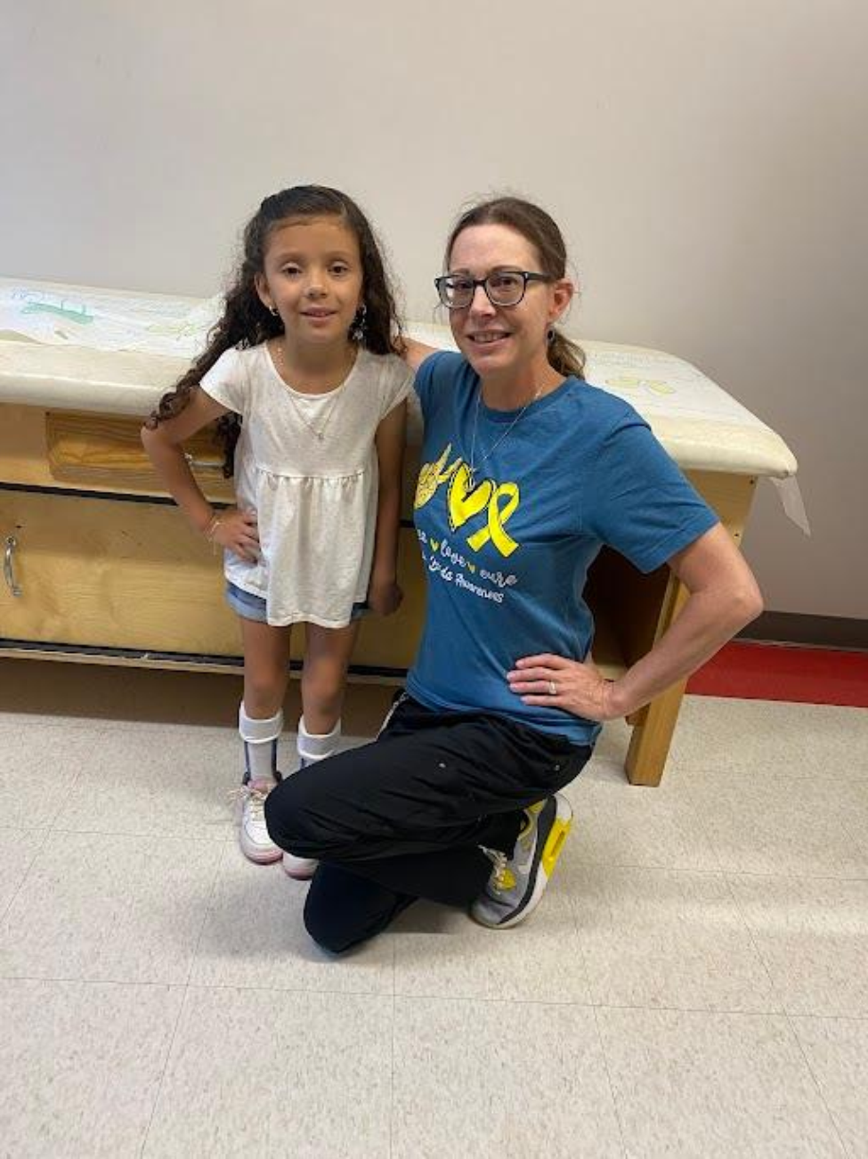 Alison poses for a photo with pediatric orthopedic surgeon Lindsay Crawford, MD, in clinic. (Photo provided by Shelly Casey)