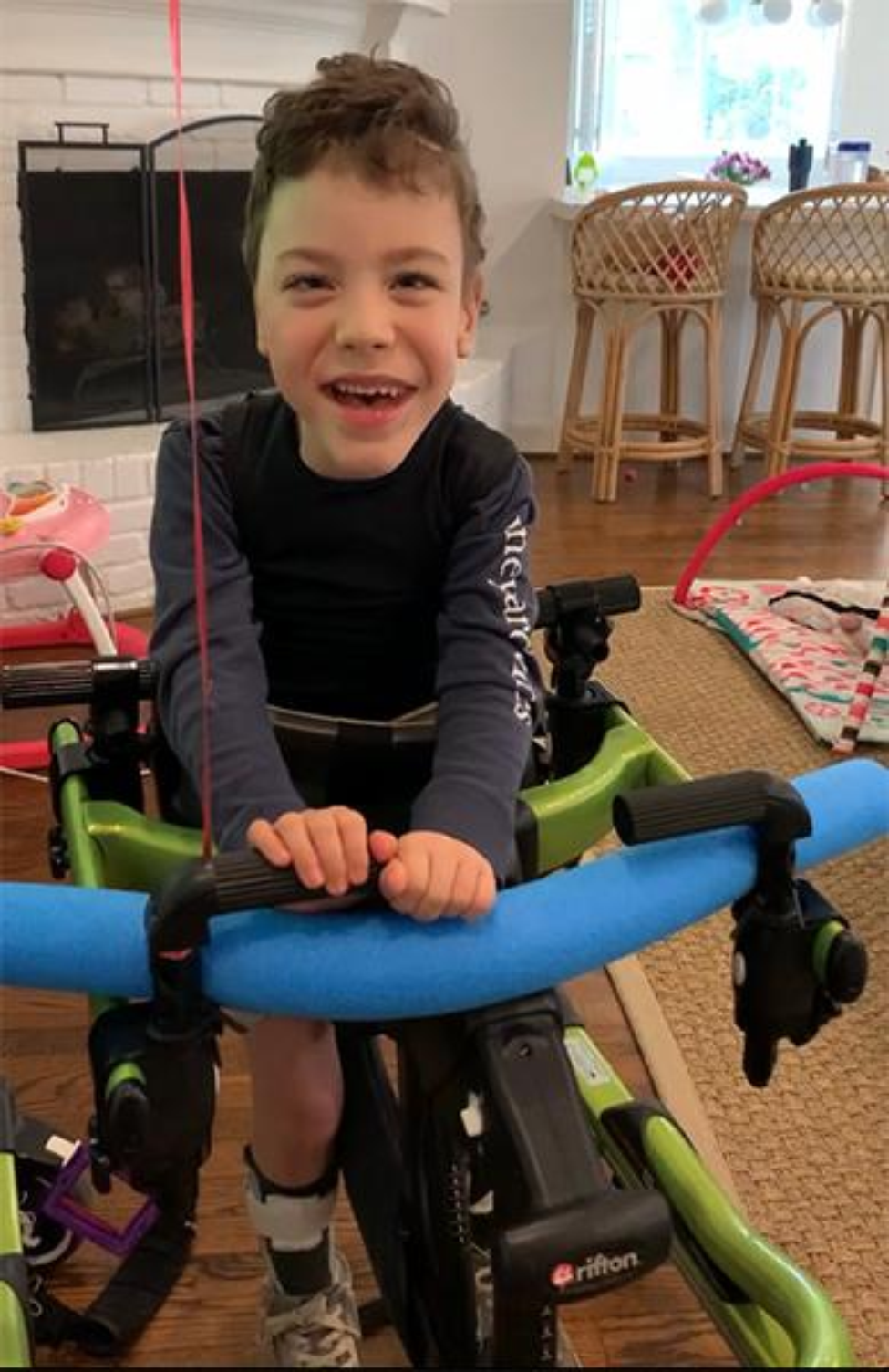 Photo of Robert Ryan who can now take steps using a gait trainer as part of his physical therapy. (Photo courtesy of Laura Ryan)