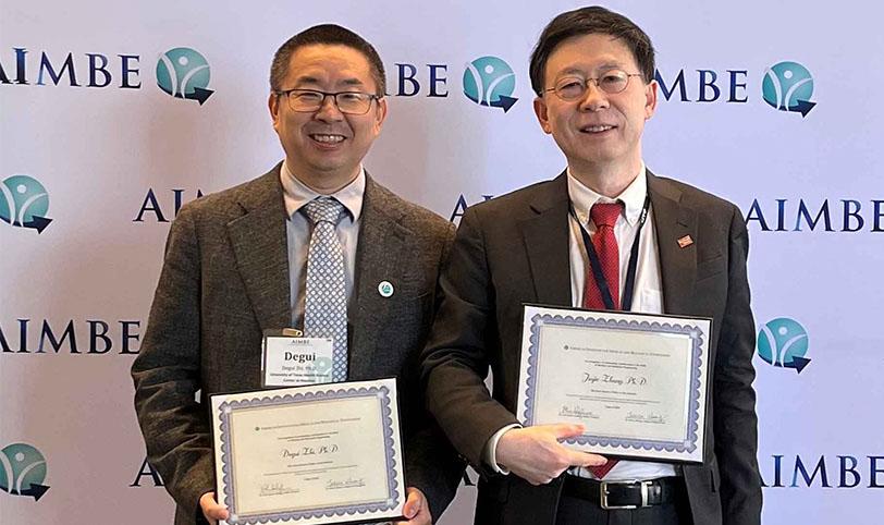 Degui Zhi, PhD, MS (left) and Jiajie Zhang, PhD at the 2025 AIMBE College of Fellows Induction Ceremony