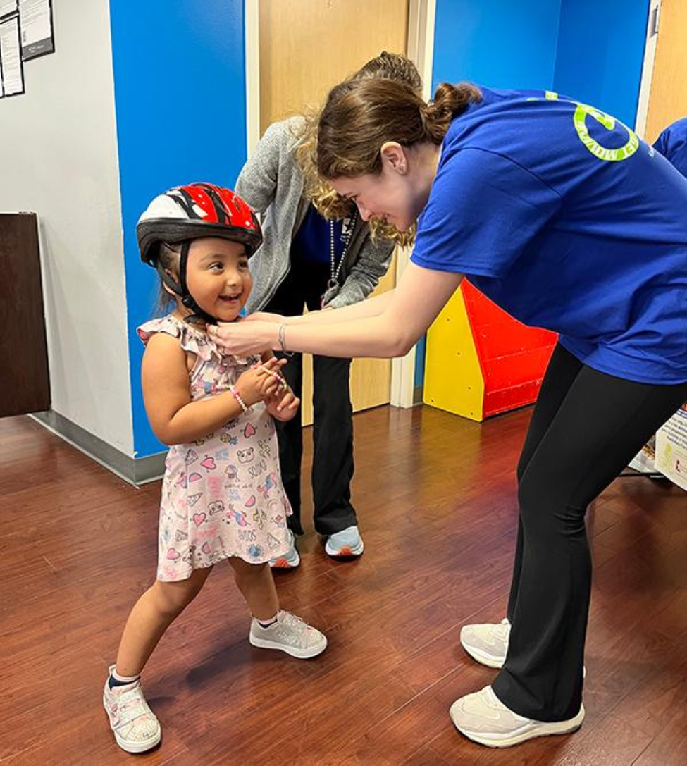 At the event, kids learned how to properly fit a helmet on their heads and how to safely ride bikes. (Photo by Simone Sonnier/UT Physicians)