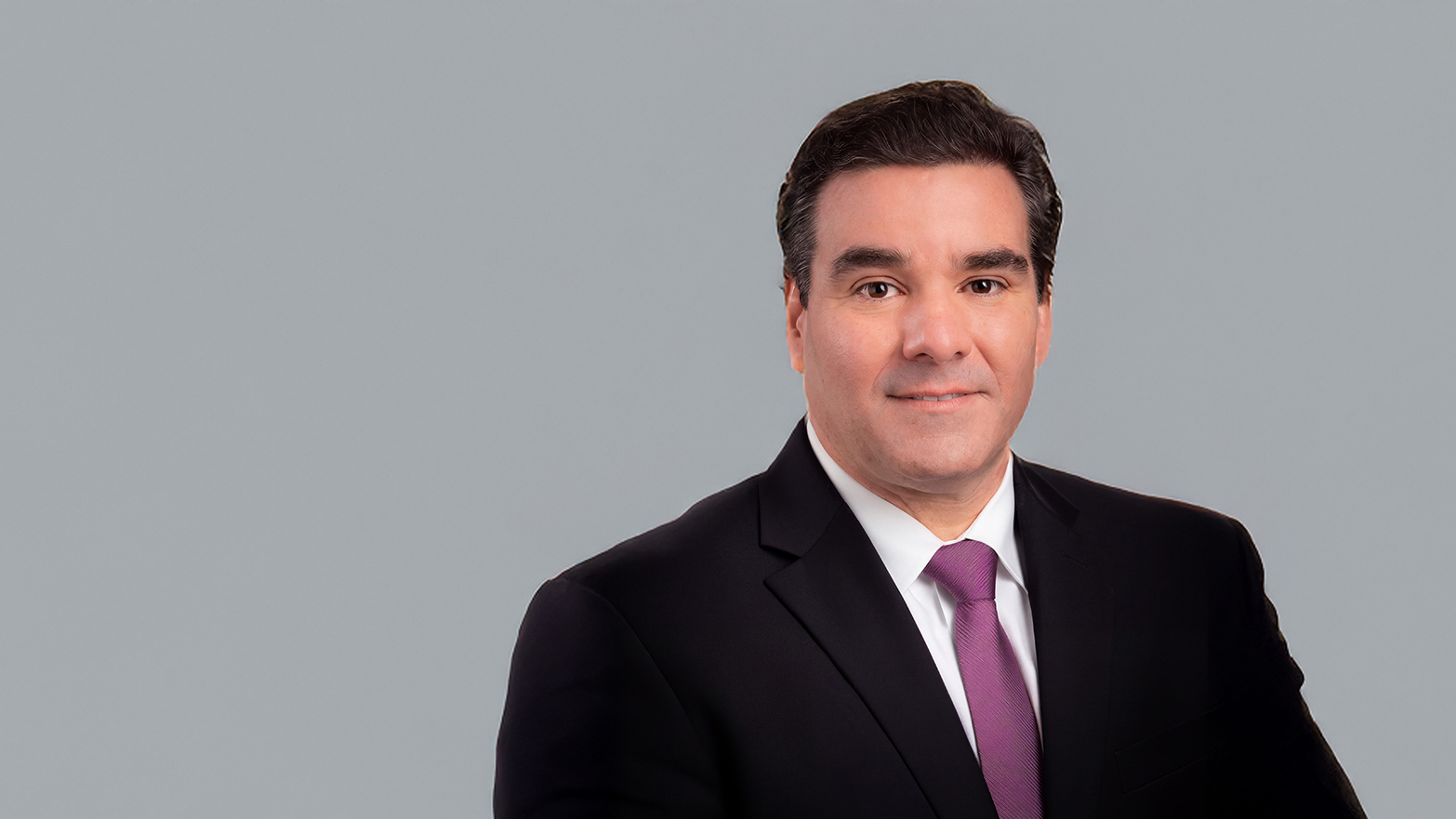 Renato M. Silva, DDS, dean of UTHealth Houston School of Dentistry, wearing a black suit and purple tie.