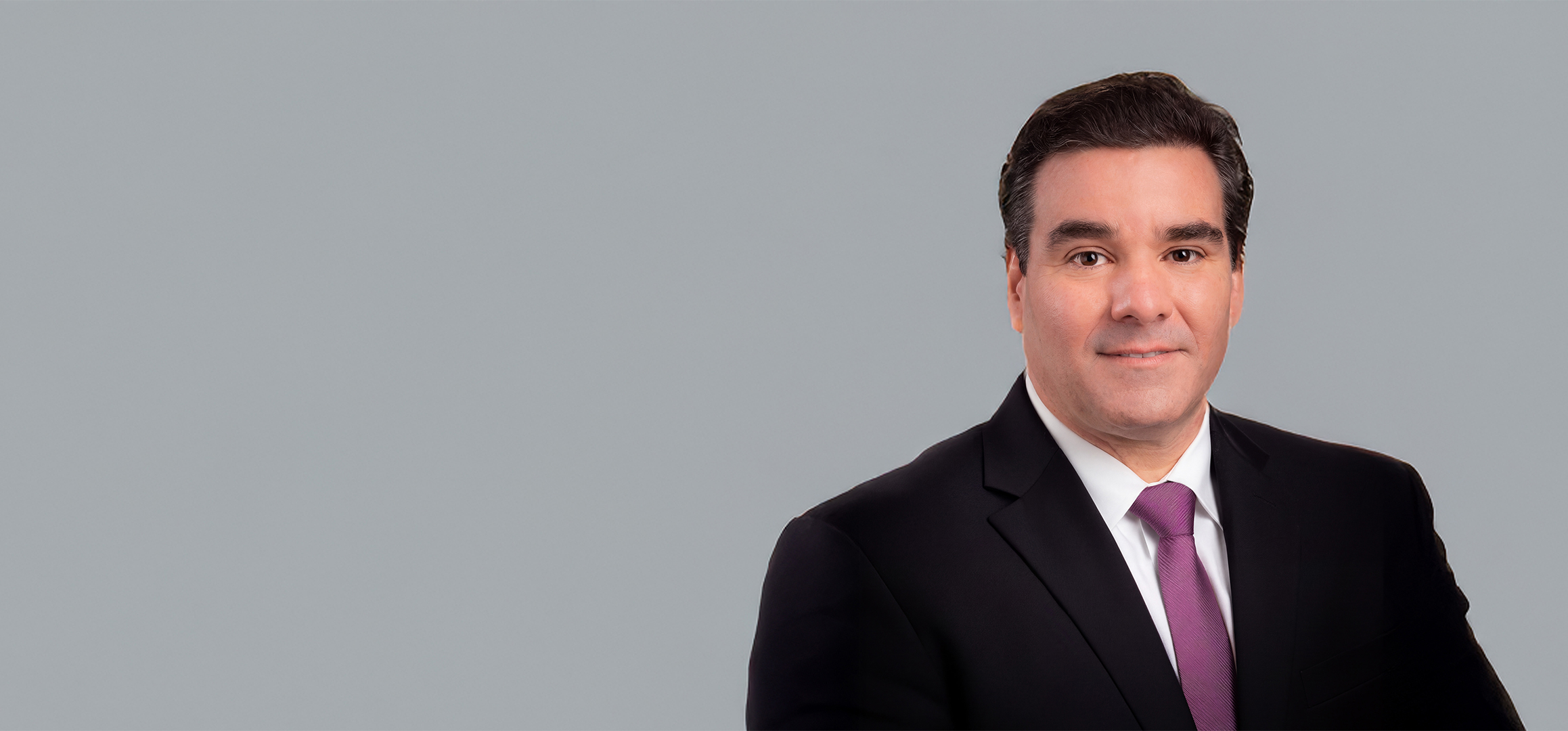 Renato M. Silva, DDS, dean of UTHealth Houston School of Dentistry, wearing a black suit and purple tie.