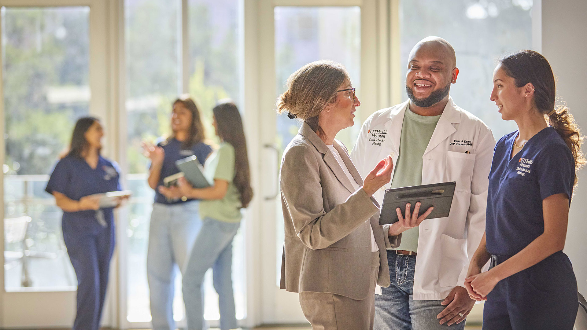 Three nursing students chat in an informal setting