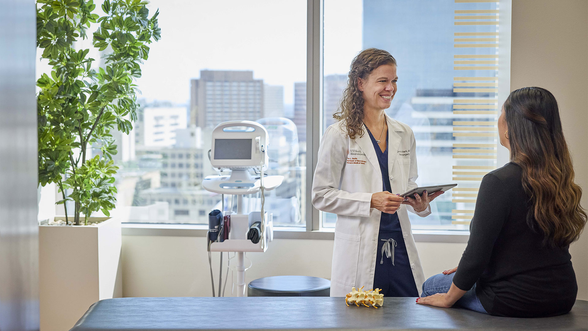 Doctor meeting with a patient in a brightly-lit modern office