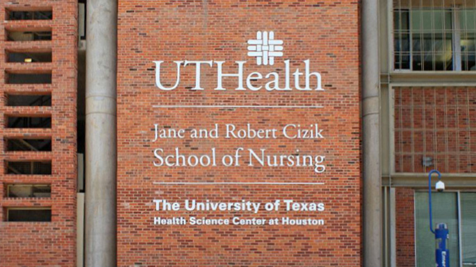 Exterior signage on the brick wall of the UTHealth Houston Jane and Robert Cizik School of Nursing, displaying the university's name and logo.