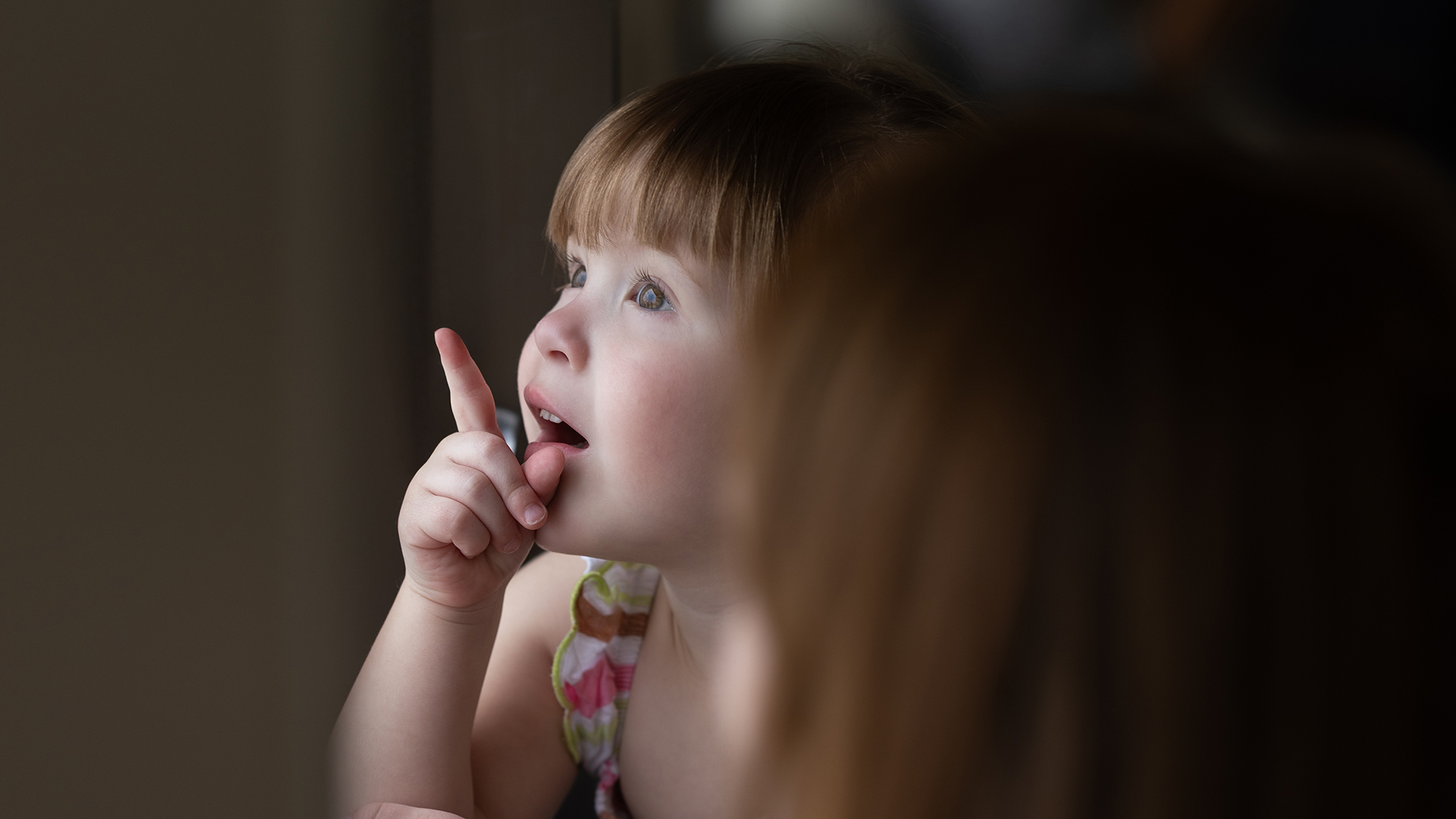 Lily Nail staring out a window