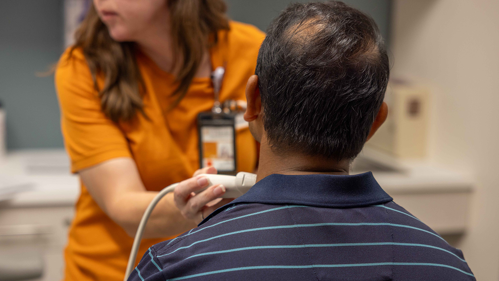 UTHealth Houston staff member performs a vascular screening on an attendee during the health fair.