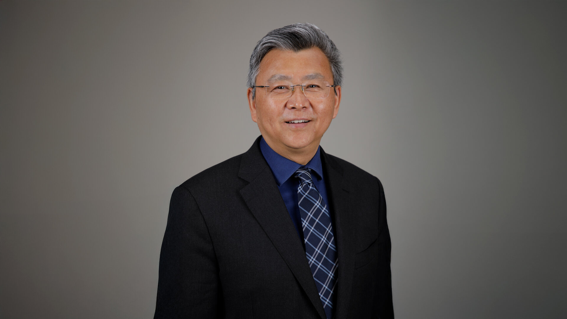 Close view of orange UTHH tapestry logo against a light grey background