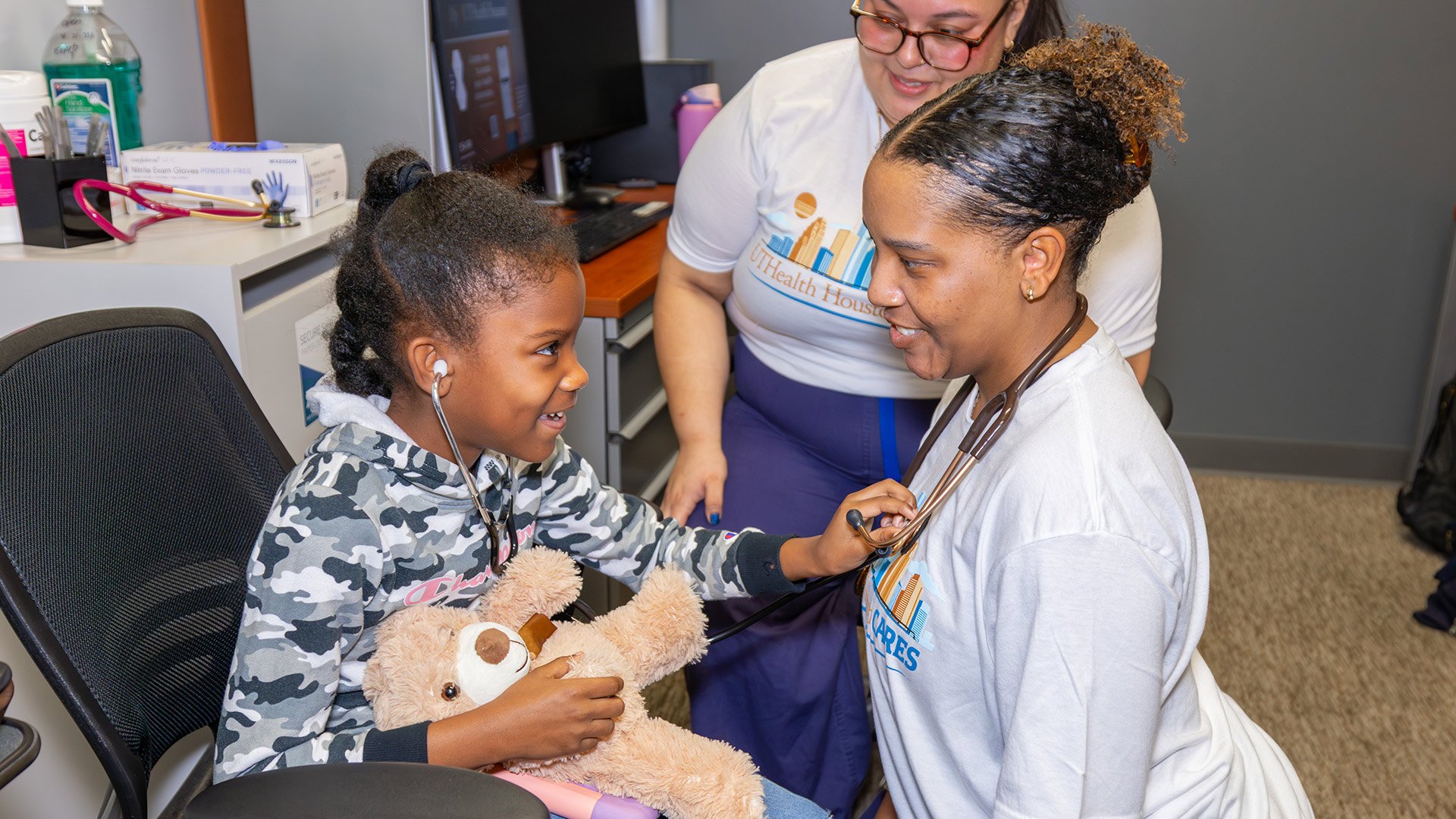 students interacting with child patient during health fair