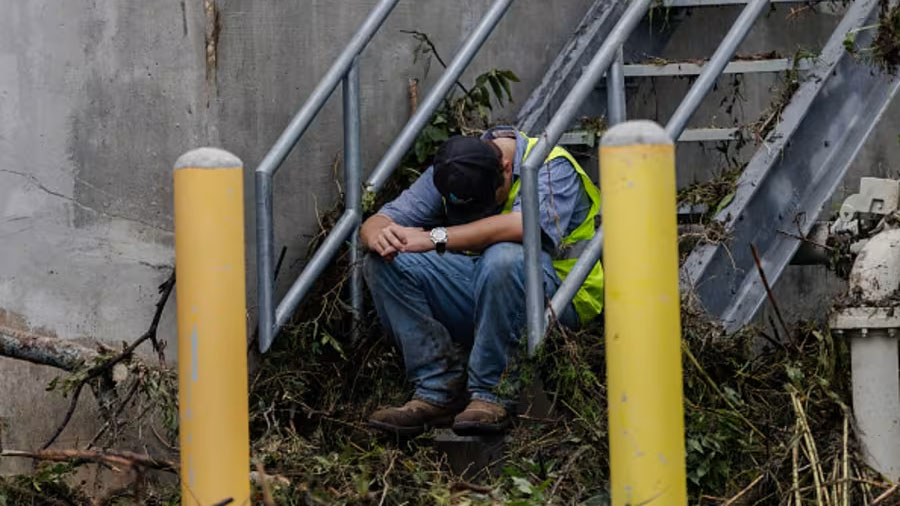 First responder with head down on a staircase